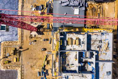 Worker is managing an elevated cherry picker at building site. aeria view