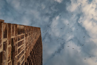 Low angle view of wall against sky