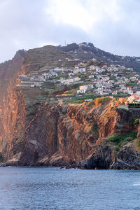 Panoramic view of sea and buildings against sky