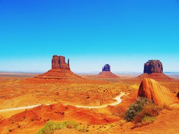 Rock formation at monument valley against clear blue sky