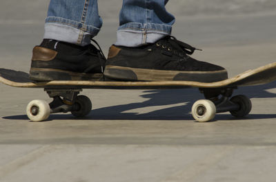 Low section of man skateboarding outdoors