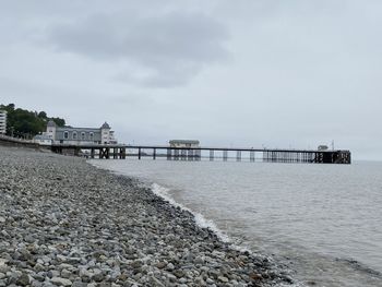 Pier over sea against sky