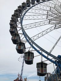 Low angle view of ferris wheel against sky