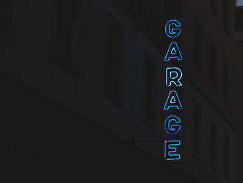 Illuminated garage text against building