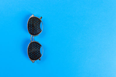 High angle view of blackberries against blue background