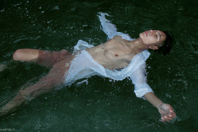 High angle view of young man swimming in lake