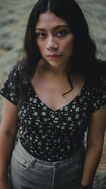 Portrait of young woman standing outdoors