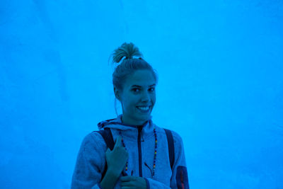 Portrait of smiling young woman in ice cave