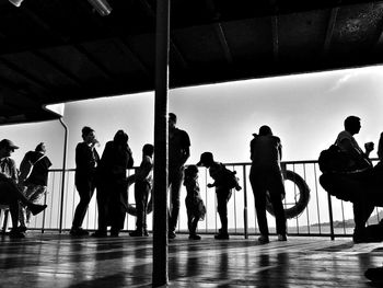 Silhouette people standing on floor