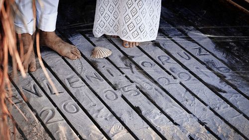 Low section of woman standing on tiled floor