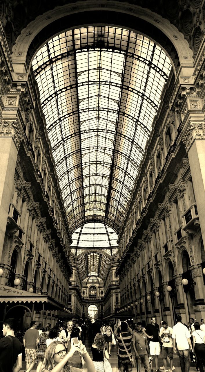 indoors, ceiling, architecture, built structure, arch, interior, window, low angle view, large group of people, skylight, men, architectural feature, travel, famous place, history, incidental people, travel destinations, architectural column, tourism