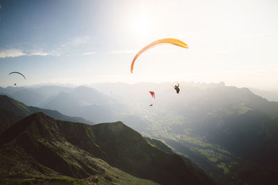 Low angle view of person paragliding against sky