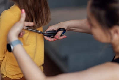 Side view of woman using mobile phone at home