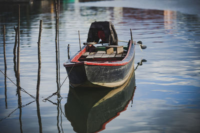 Old wooden boat floating over plain water