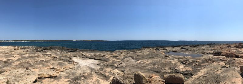 Scenic view of sea against clear blue sky