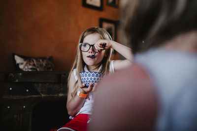 Portrait of happy girl holding eyeglasses