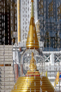 Beaded curtains hanging around stupa at wat phitchaya yatikaram worawiharn