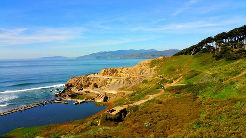 Scenic view of sutro baths ruins and sea and mountains against blue sky