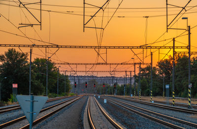 Railroad tracks against sky during sunset