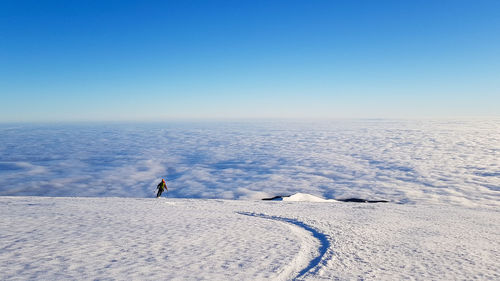 Scenic view of snowcapped landscape against clear blue sky