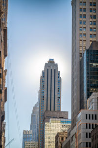 Modern buildings in city against clear sky