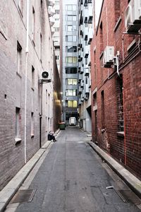 Narrow street amidst buildings in city