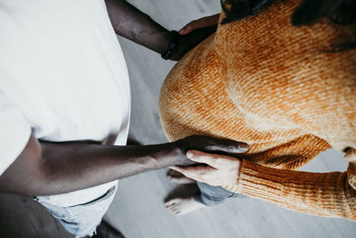 Young man touching pregnant woman' s stomach at home