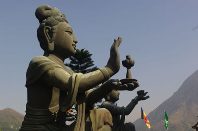 Low angle view of statue against sky