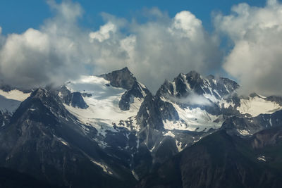 Panoramic view of snowcapped mountains against sky