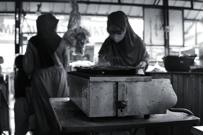 Rear view of man preparing food