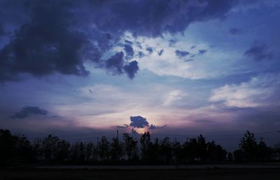 Silhouette trees against sky during sunset