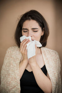 Close-up of woman suffering from cold