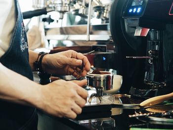 Close-up of man preparing food in cafe