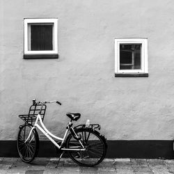 Bicycle parked on wall of building