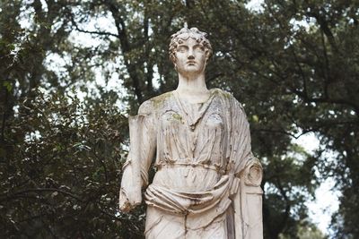 Statue against trees and plants