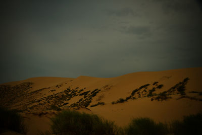 Scenic view of desert against sky at dusk