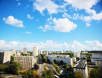 Buildings in city against cloudy sky