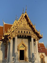Low angle view of historical building against clear blue sky