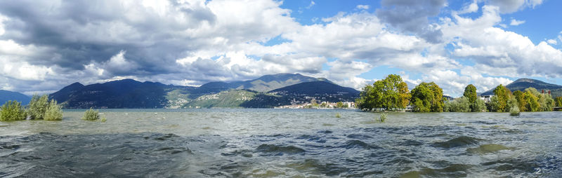 Panoramic view of sea and mountains against sky