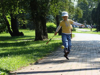 Full length of boy walking on grassland