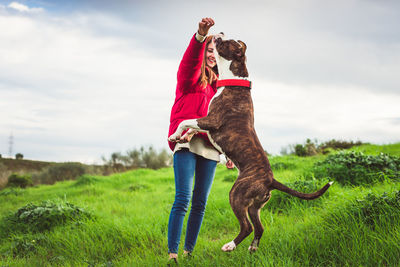 Woman with dog on field