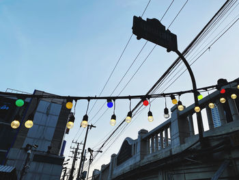 Low angle view of illuminated street light against sky