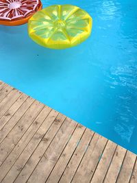 High angle view of yellow swimming pool in sea