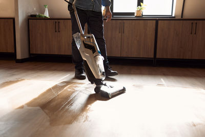 Low section of man skateboarding on floor