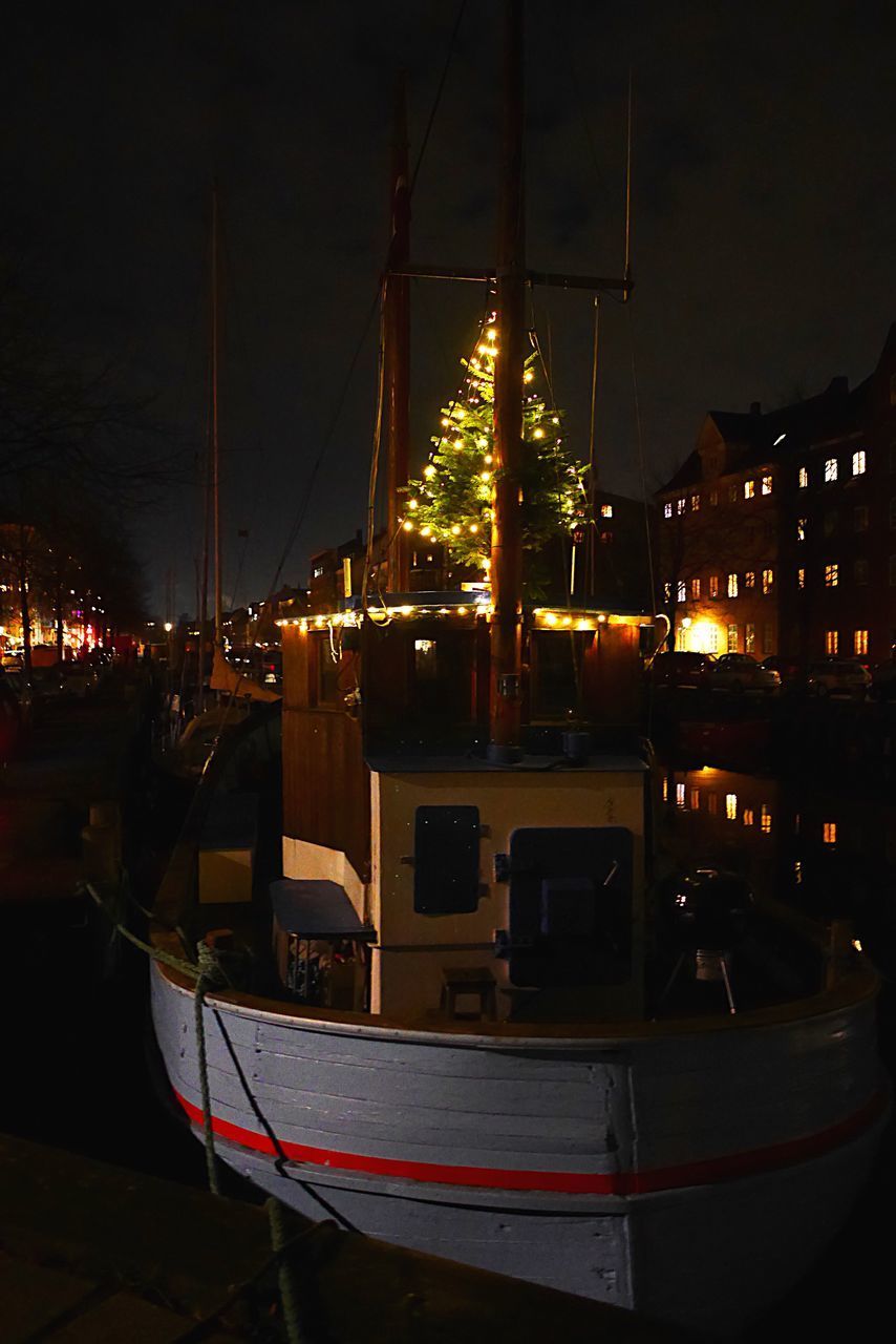 ILLUMINATED HARBOR AGAINST SKY AT NIGHT