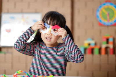 Portrait of cute boy holding camera