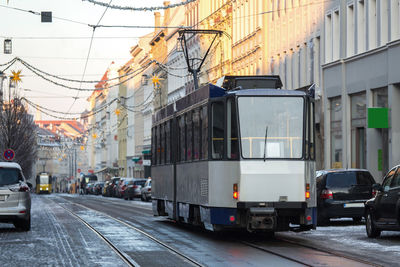 Cars on road in city against sky