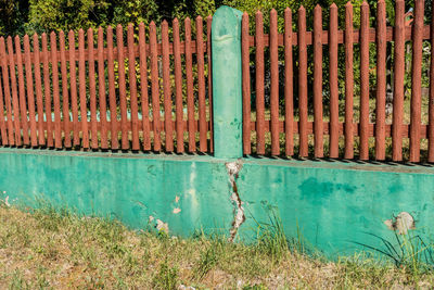 Blue metal fence on field