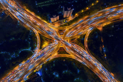 Aerial view of light trails on elevated road in city at night