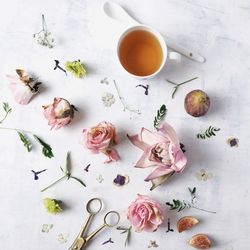 High angle view of flowers and tea cup on table
